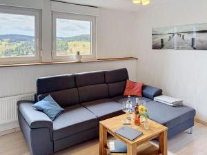 a living room with a couch and a table at Apartment Blackforest Birdnest by Interhome in Schonach