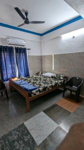 a bedroom with a bed and a ceiling at HOLIDAY HOMEs MALPE in Udupi +13 photos