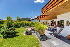 a backyard of a house with a patio at Villa Mona Lisa in Seefeld in Tirol