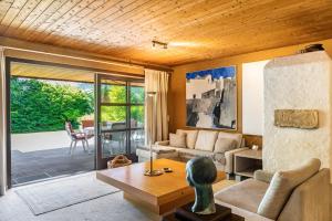 a living room with a couch and a table at Villa Mona Lisa in Seefeld in Tirol