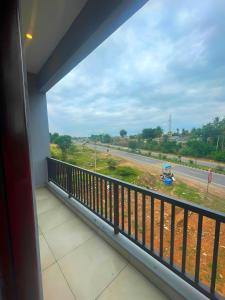 a balcony with a view of a road at GR Comforts Boarding and Lodging in Hirehalli