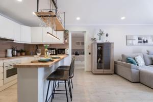 a kitchen and living room with a bar and a couch at Paz Ocean View Luxury, 2 Air conditioners, Fast Wifi, Heated pool in San Miguel de Abona