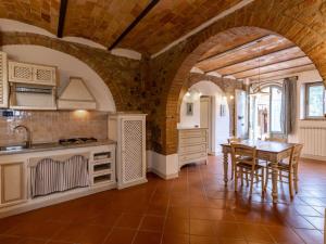 a kitchen with a table and chairs in a room at Apartment Torrenieri by Interhome in Vergelle