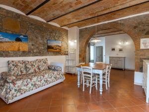 a living room with a couch and a table at Apartment Torrenieri by Interhome in Vergelle