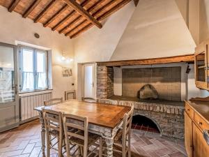 a dining room with a table and a fireplace at Apartment Pienza by Interhome in Vergelle