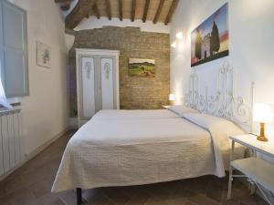 a bedroom with a large white bed in a room at Apartment Pienza by Interhome in Vergelle