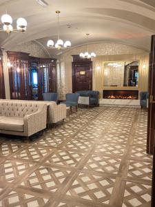 a lobby with a couch and chairs and a fireplace at The Newgrange Hotel in Navan