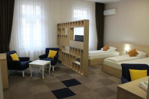 a hotel room with two beds and a television at Hotel Story in Sarajevo