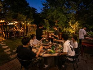 a group of people sitting around a table with food at beau lac biwako in Takashima