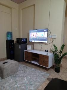 a living room with a flat screen tv on a wall at Voi town CBD homes in Voi