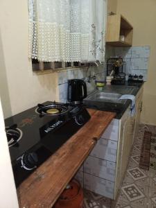 a kitchen with a stove and a sink at Voi town CBD homes in Voi