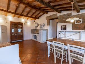 a kitchen with a table and chairs in a room at Apartment Asciano by Interhome in Vergelle