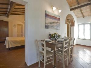 a dining room with a table and chairs and a bed at Apartment Siena by Interhome in Vergelle