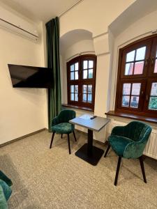 a room with two chairs and a table and a tv at Hotel&Restauracja Zamek Bytów in Bytów +130 photos