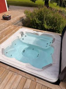 a hot tub in a tent on a deck at Landhaus Måsberget in Kristinehamn +17 photos