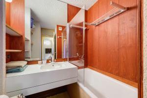 a bathroom with a sink and a mirror at Grand studio Cosy divisible in Valmorel +14 photos