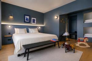 a bedroom with a large bed and a blue wall at Maison Arya in Brussels