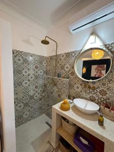a bathroom with a sink and a mirror at Riad Dar Fena By K&G &jacuzzi in Marrakesh +49 photos