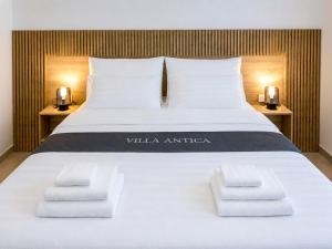 a large white bed with two towels on it at Villa Antica by Interhome in Lopar