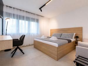 a bedroom with a bed and a desk and a chair at Villa Antica by Interhome in Lopar