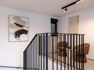 a room with a staircase with a chair and a couch at Villa Antica by Interhome in Lopar +26 photos