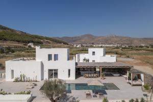 an aerial view of a white house with a pool at Villa Bema - Quietness and Beach access in Molos Parou