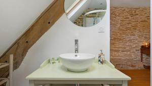 a bathroom with a white sink and a mirror at Gite champêtre in Tréal +17 photos