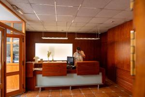 a man standing at a desk in an office at Hotel Rey Don Jaime in Morella