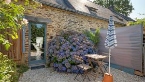 a large flower bush in front of a house at Gite champêtre in Tréal