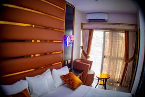 a hotel room with a bed and a window at Pretelia Hotel in Warri