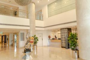 a lobby with potted plants in a building at Radisson Blu Kochi in Cochin +90 photos