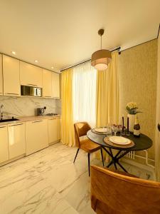 a kitchen and dining room with a table and chairs at Jacuzzi With light Nauki Avene in Kharkiv