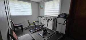 a gym with two exercise bikes in a room at Gite L'évasion à Cheneux Stoumont in Stoumont