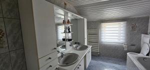 a bathroom with two sinks and a mirror at Gite L'évasion à Cheneux Stoumont in Stoumont +40 photos