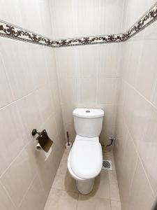a bathroom with a white toilet in a room at Nest at Imaara in Nairobi