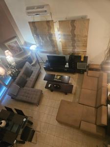 a living room with a couch and a table at paralia ofriniou beautiful house in Karianí
