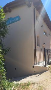 a white building with a sign on a balcony at Strada Facendo in Collebrincioni