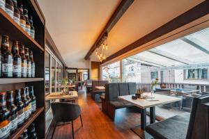 a restaurant with tables and chairs in a room at Schinkels Brauhotel in Witzenhausen