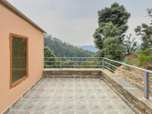 a balcony with a view of a mountain at Silent Stone Homestay in Almora