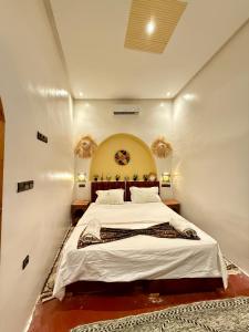 a bedroom with a large bed in a room at Dar Zagora Oasis - Authentic Moroccan Stay in Zagora