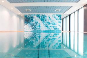 a room with a glacier mural on the wall at City Hotel Roding in Roding