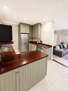 a kitchen with a large counter top in a room at Three on Firmount in Somerset West +8 photos