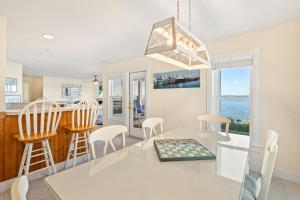 a kitchen and dining room with a table and chairs at BCBPV1411 Ballast Point in Manteo