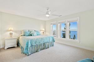 a white bedroom with a bed and a window at BCBPV1411 Ballast Point in Manteo +31 photos