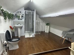 a bathroom with a shower and a toilet and a sink at The Bickerton Poacher in Higher Burwardsley +51 photos