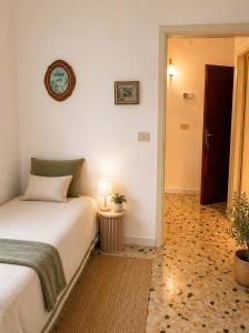 a bedroom with a bed and a clock on the wall at Alba Holiday in Vallecorsa