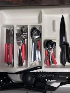a white container filled with utensils in a drawer at Ferienwohnung Nordheim in Nordheim