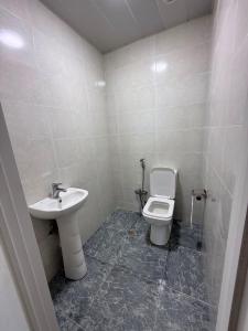 a bathroom with a sink and a toilet at Sumgait Boulevard View Apartment in Sumqayıt +11 photos