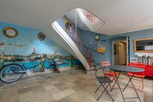 a room with a staircase with a bike on the wall at Flensbed Hotel & Hostel in Flensburg
