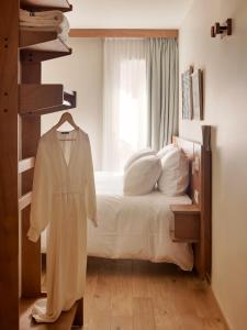 a white bedroom with a bed and a window at Alfred Hotels Toulouse Victor Hugo - Hôtel Rénové in Toulouse